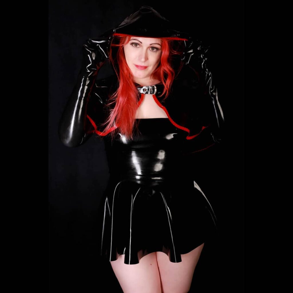 Latex Nikki wearing black latex dress and hood