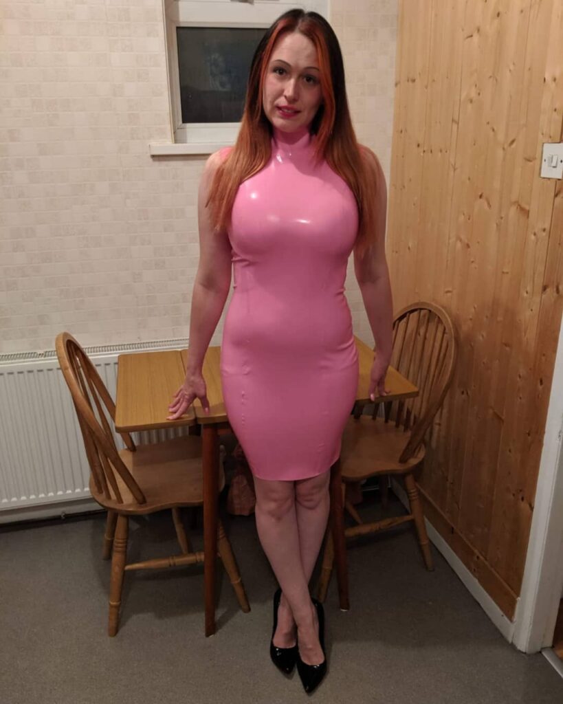 Latex Nikki wearing a pink latex dress