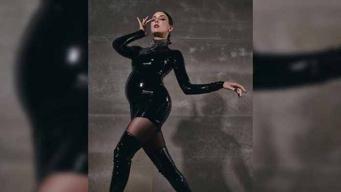 MARUV Wears Latex Dress to Announce Her Pregnancy