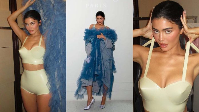 Kylie Jenner wears Latex lingerie under Maison Margiela coat to Maison Margiela Menswear Fall/Winter 2023 launch
